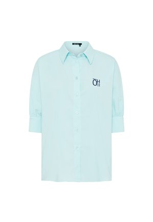 Light blue button-up shirt with three-quarter sleeves and dark blue "OH LA LA" text on the left chest.