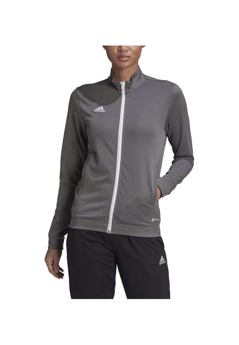 Gray zip-up jacket made of moisture-wicking material, featuring a high collar, long sleeves, and white zipper. Logo on the chest.
