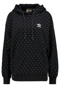 Svart Adidas-hoodie med vitt triangulärt mönster, framficka med kenguruöppning, dragsko på huvan och vit Adidas trefoil-logga på bröstet.