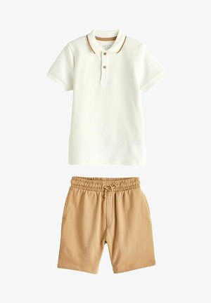 White, textured short-sleeve polo with brown collar accents, paired with beige drawstring shorts featuring pockets.
