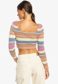 Gestreiftes, geripptes Cropped-Top in Farben wie Braun, Pink, Blau und Grün; lange Ärmel mit weitem Ausschnitt und figurbetontem Design.