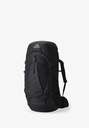 Sac à dos noir en tissu texturé, détails verts, bretelles réglables, fermeture à rabat supérieur et poches latérales pour un accès facile.