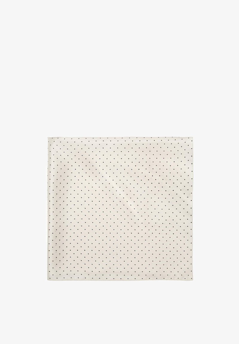 Kremowy kwadratowy materiał z równomiernie rozmieszczonymi małymi czarnymi grochami.