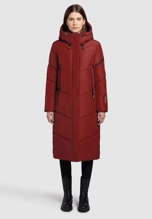 Long red puffer coat with a hood, quilted design, side pockets, and snap closures. Black accents on zippers and cuffs.