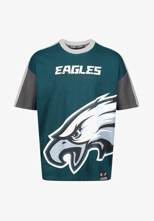 T-shirt en turquoise et gris, arborant un grand graphique d'aigle et le texte 'EAGLES Philadelphia' en blanc. Manches courtes et col rond.