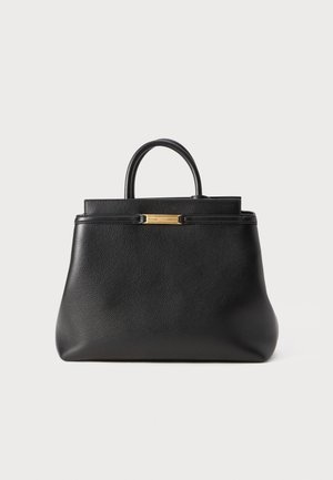 Black leather handbag with a structured design, semi-gloss texture, a top handle, and a gold accent on the front. No additional details.