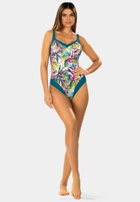Jednoczęściowy strój kąpielowy z kolorowym wzorem kwiatowym i zielonymi akcentami, z regulowanymi ramiączkami i dekoltem w kształcie litery V. Gładka tekstura tkaniny.