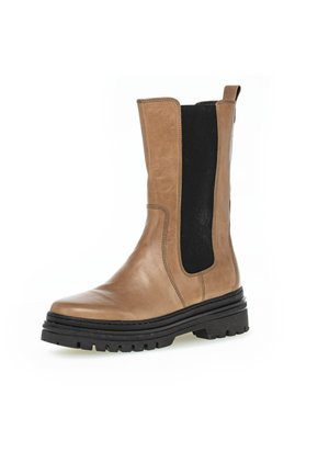 Brown leather ankle boot with elastic side panels, rounded toe, chunky black sole, and stitching details for added texture and durability.