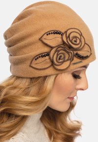 Gorro de lana color beige con un diseño holgado, que presenta rosas bordadas en marrón y detalles de cuentas para un toque adicional.