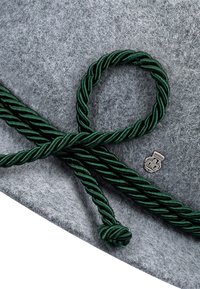 Grey felt hat featuring a twisted dark green rope band and a metallic crest. The rope creates a decorative knot detail.