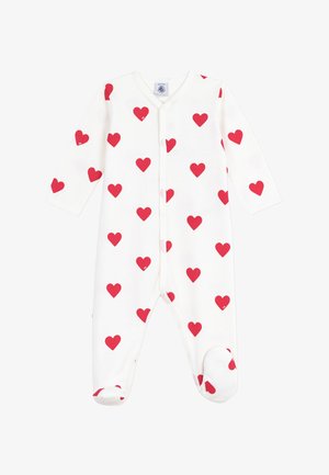 Un body en coton blanc à manches longues, avec un motif de cœurs rouges, des boutons-pression sur le devant et une conception avec chaussons pour plus de chaleur.