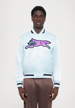 Light blue satin bomber jacket featuring a large purple and teal graphic of a leaping cat. Ribbed navy cuffs and hem.