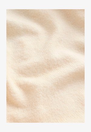Cremefarbener, strukturierter Stoff mit einer weichen, flauschigen Oberfläche und subtilen Rippungen, die sanfte Falten und Wellen zeigen.