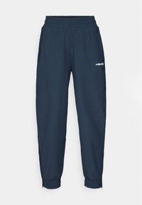 Tumši zili sporta bikses ar elastīgu jostiņu, divām sānu kabatām un elastīgiem aproču galiem potītēs. Priekšā ir balts "HEAD" logo.