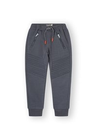Pantalones de chándal grises con textura acanalada en las rodillas, dos bolsillos con cremallera y una cintura con cordón de ajuste con detalles en color naranja.