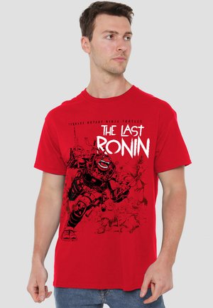 Red cotton t-shirt featuring a graphic print depicting a character in armor with a sword, labeled "The Last Ronin" in bold white text.