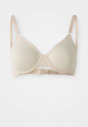 Beige padded bra with adjustable straps, smooth texture, underwire support, and hook-and-eye closure at the back. Simple design.