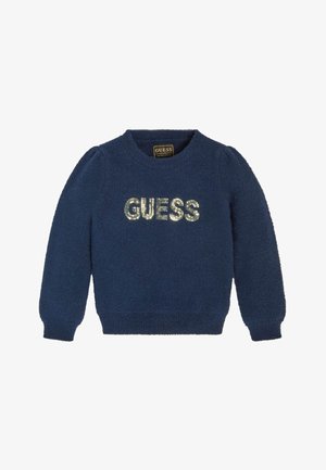 Granatowy, puszysty sweter z długimi rękawami i napisem "GUESS" wykonanym ze srebrnych cekinów na piersi.