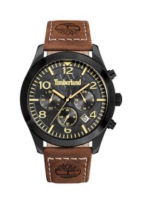 Orologio Timberland con cassa in metallo nero. Il quadrante nero presenta numeri gialli, tre subquadranti, una finestra per la data e un cinturino in pelle marrone con il logo.