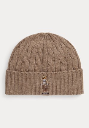 Brown knitted beanie with a ribbed cuff and cable pattern, featuring an embroidered bear wearing a suit, with "POLO" text in blue.