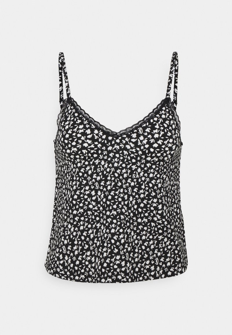 Haut camisole noir avec fines bretelles, petit motif floral blanc et bordure en dentelle le long du décolleté en V.