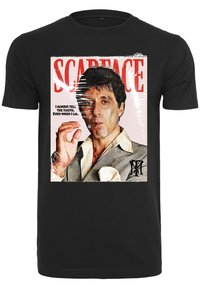 Black short-sleeve T-shirt featuring a graphic print of a man in a suit, holding a cigarette, with "Scarface" and a quote in red text above.