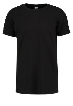 Tricou negru cu mânecă scurtă, fabricat dintr-un material neted. Prezintă detalii cu nervuri pe umeri, decolteu rotund și o croială lejeră.