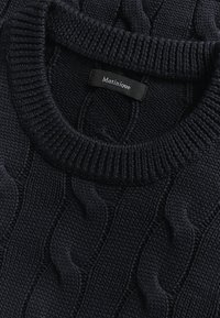 Maglione di colore navy a trama a trecce, con scollo rotondo a costine e etichetta del marchio "Matinique" cucita all'interno.