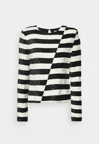 Haut à manches longues rayé noir et blanc avec motif à rayures diagonales sur le devant et encolure ronde.