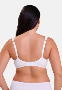 White bra with adjustable straps and hook-and-eye closure, featuring a smooth fabric texture and minimal design, viewed from the back.