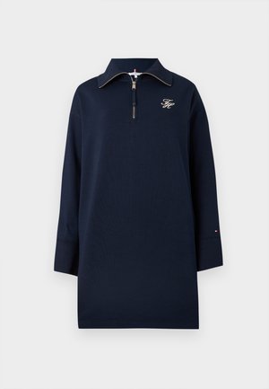 Navy pullover with a zipper, featuring long sleeves and a collared neck. Embroidered logo on the chest and accent details on the cuffs.
