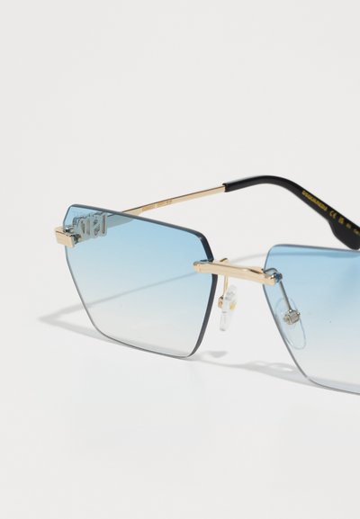Square sunglasses with a gradient blue lens, gold metal frames, and clear nose pads. Features a logo on the lens and black temple arms.