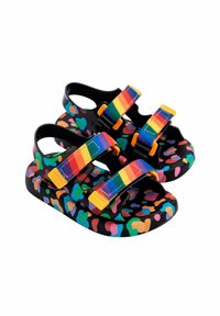 Sandali colorati con base nera caratterizzati da una stampa leopardata multicolore. Due cinturini regolabili in colori dell'arcobaleno con dettagli arancioni.
