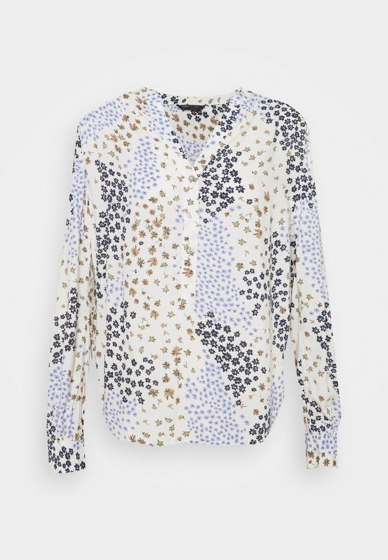 Blusa a maniche lunghe con motivo floreale in crema, caratterizzata da diversi disegni di fiori blu, neri e marroni, con scollatura a V e chiusura con bottone.