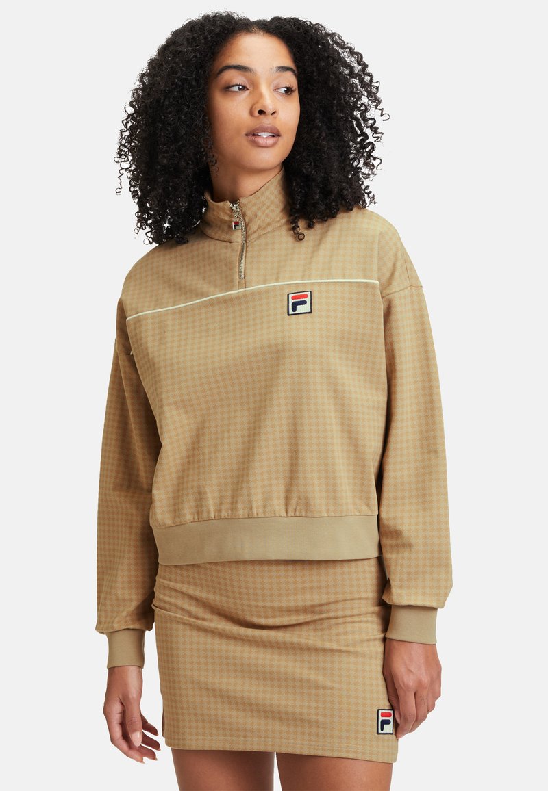 Felpa zip-up marrone con motivo a scacchi e gonna aderente coordinata. Presenta polsini a costine, vita elastica e patch con logo.