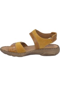 Yellow leather and suede sandal with open design, adjustable straps, cushioned insole, and textured rubber sole for grip.