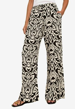 Pantaloni a gamba larga in bianco e nero a motivi, con vita elastica, caratterizzati da un design audace e fluido, e tasche laterali.