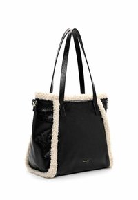 Black leather tote bag with beige fleece trim, smooth texture, structured shape, double shoulder straps, and a gold accent logo on the side.