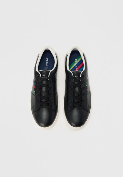 Čierne kožené tenisky s bielymi gumovými podrážkami, vybavené čiernymi šnúrkami, farebným detailom na boku a viacfarebným vzorom vnútornej vložky.