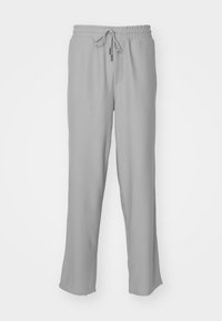 Grijze geribbelde joggerpants met een elastische tailleband en verstelbaar koord. Heeft zijzakken en een relaxte pasvorm door de benen.