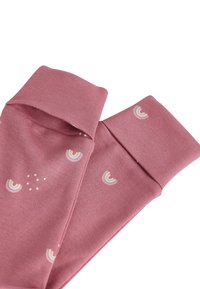 Chaussettes en coton rose au toucher doux, ornées de petits motifs arc-en-ciel brodés et de points blancs, pliées au niveau des poignets.