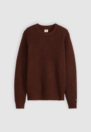 Brown waffle-knit long-sleeve crewneck sweater with ribbed cuffs and hem, displayed on a gray background.