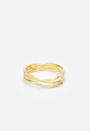 Delicate gold ring with three intertwined, slightly twisted bands forming a minimalist and elegant design on a white background.