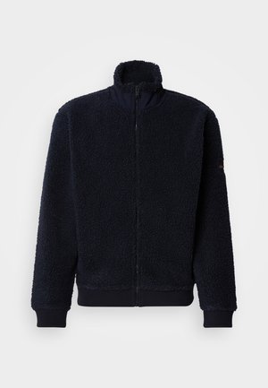 Marineblaue Fleecejacke mit hohem Kragen, Reißverschluss vorne, gerippten Bündchen und Saum. Weicher, strukturierter Stoff mit lockerem Schnitt und minimaler Markenkennzeichnung.