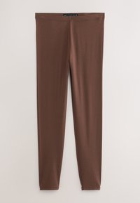 Leggings marroni a tutta lunghezza con vestibilità slim e vita elastica, mostrati su uno sfondo chiaro semplice.