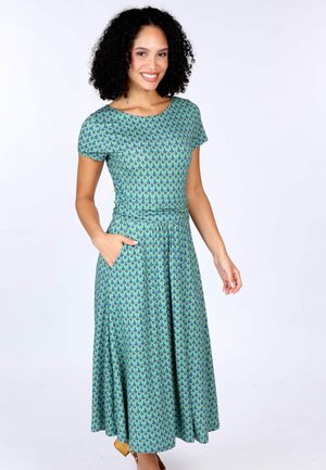 Kurzärmliges, knielanges Kleid in Grün mit einem blauen Muster. Verfügt über ein tailliertes Oberteil und einen schwingenden Rock, mit seitlichen Taschen. Glatte Stofftextur.