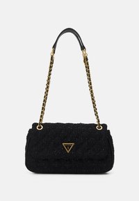 Black textured shoulder bag with gold chain strap and gold triangular Guess logo on front flap closure.