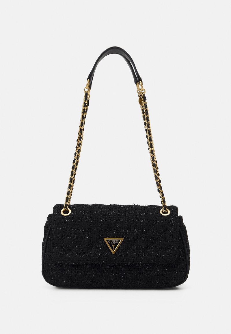 Black textured shoulder bag with gold chain strap and gold triangular Guess logo on front flap closure.