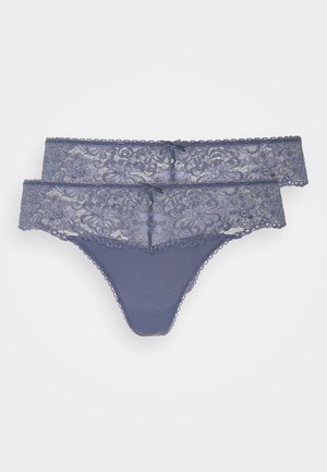 Lace thong in dark blue with a floral pattern, featuring a smooth cotton base and decorative bows at the front, finished with scalloped edges.