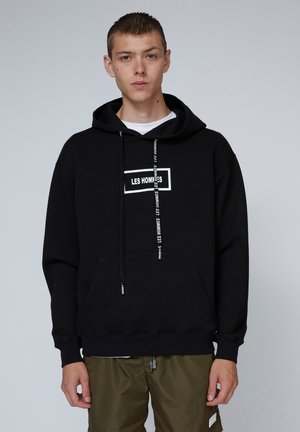 Black hoodie with a front pocket, featuring a white logo in a rectangular design. Adjustable drawstring with metallic ends. Cotton blend fabric.